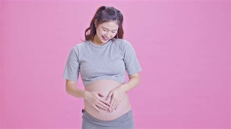 Pregnant Woman Standing Smile Stroking Big Belly Showing Thumbs Up Sign