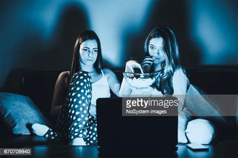 Roommates Lesbian Couple Watching Movie On Laptop At Home In Livingroom