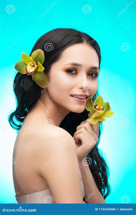A Beautiful Brunette Nude Shoulders Girl Sensually Holds A Flower Of An