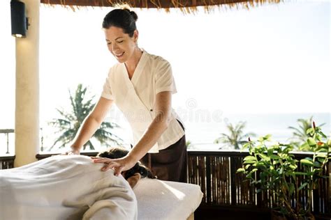 female massage therapist giving  massage   spa stock photo image