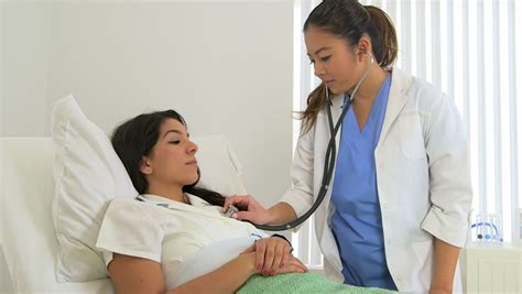 Female Doctor Examining Patient Chest With A Stethoscope Stock Footage