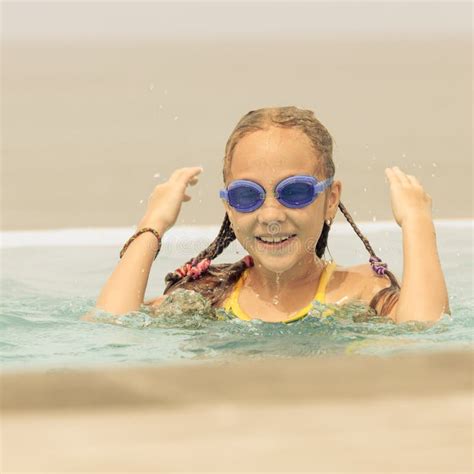teen girl sitting   swimming pool stock photo image