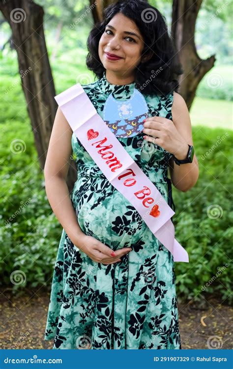 A Pregnant Indian Lady Poses For Outdoor Pregnancy Shoot And Hands On