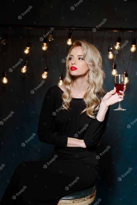 Beautiful Blonde Woman In Evening Dress Posing Holding