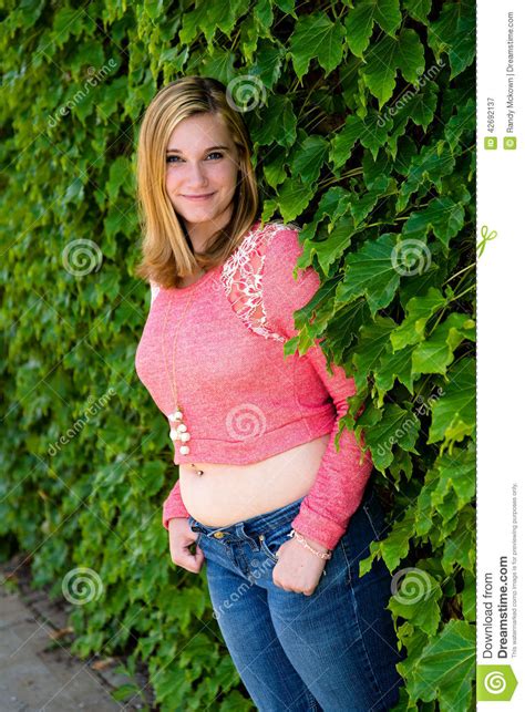Pretty Teen Girl Pink Sweater And Green Ivy Stock Image