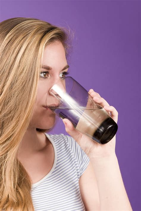 water  stock photo  young woman sipping   glass  water