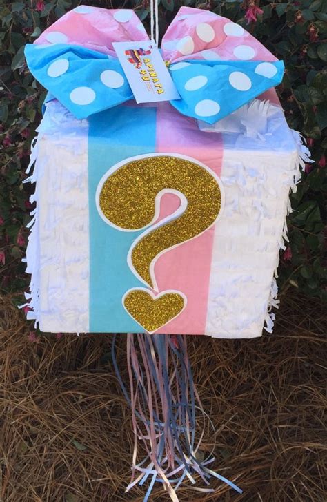 t box with pink and blue bow gender reveal piñata