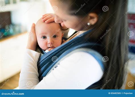 Mother At Home With Her Son In Sling Stroking Him Stock Image Image