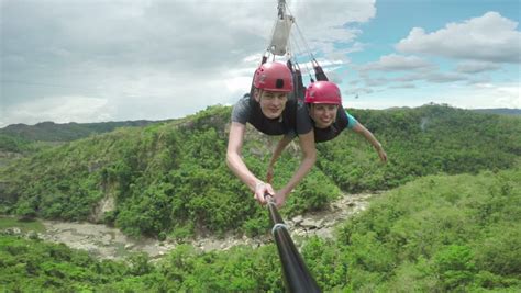 stunning footage of a couple sliding down a zipline zip line thy are quite shocked when they