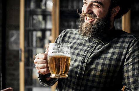man drinking beer  smiling bar  stocksy contributor lumina stocksy