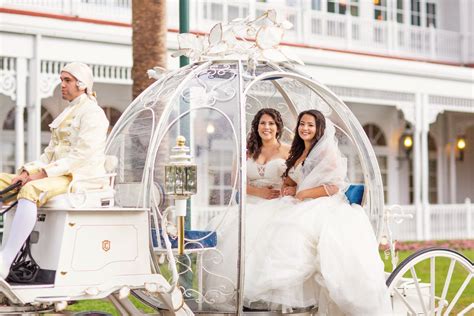 two beautiful brides in cinderella s glass coach disney wedding