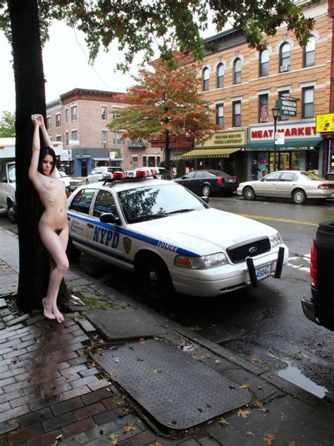 i love how she s posing beside a cop and across from the meat market