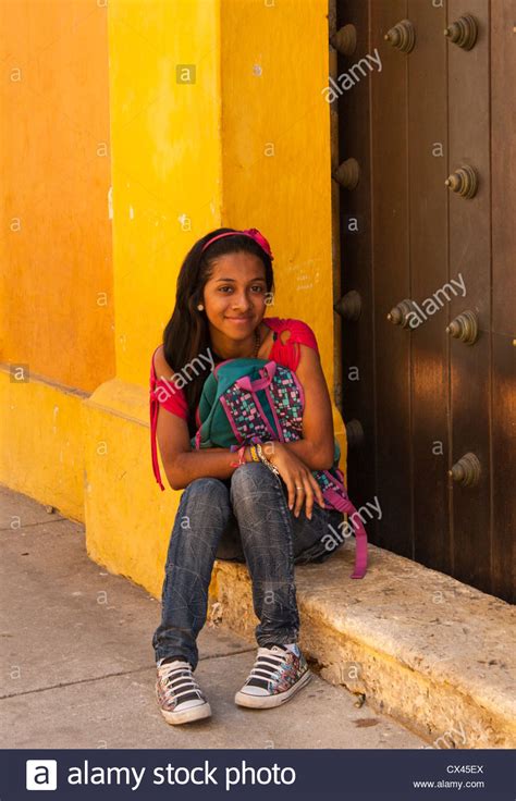 jeune fille assise dans la porte jaune bâtiment colombian caribbean