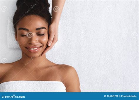 joyful african girl  face massage  spa stock photo image