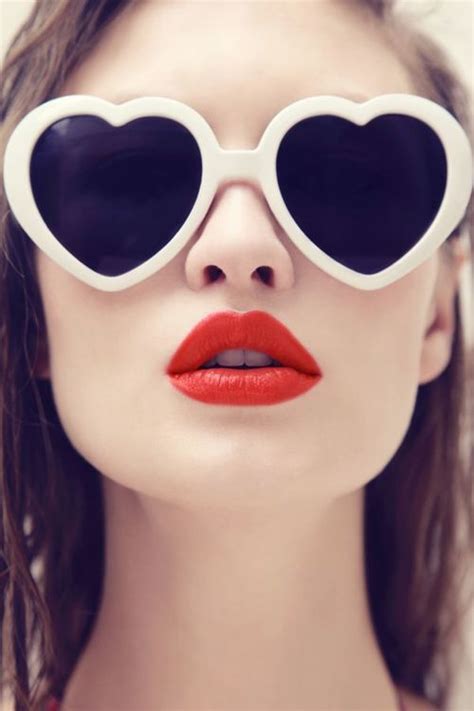 beautifully reckless red lipstick with tinted heart shaped glasses