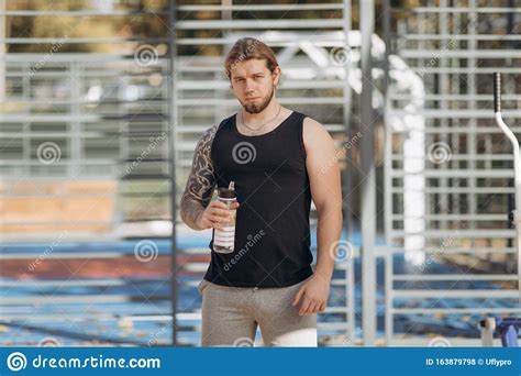 Thirsty Man Drinking Sports Cocktail From Bottle During