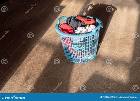 freshly laundered clothing items   blue plastic clothes basket stock image image