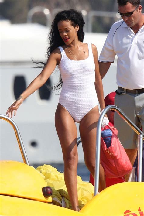 rihanna in white swimsuit posing on the boat in cannes