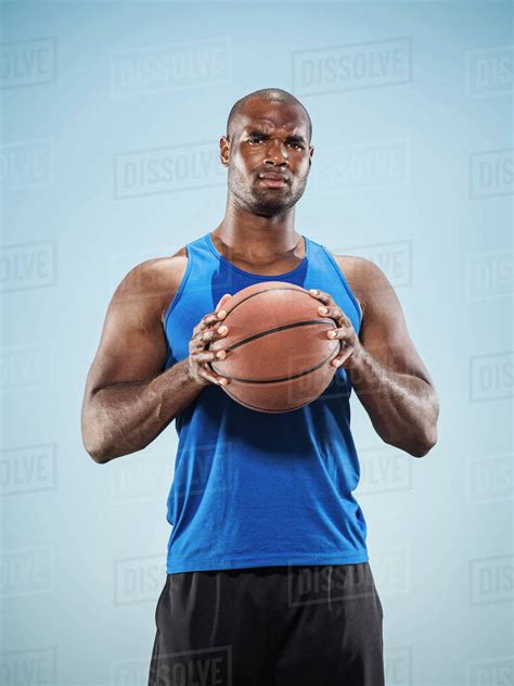 portrait   black man holding basketball stock photo dissolve