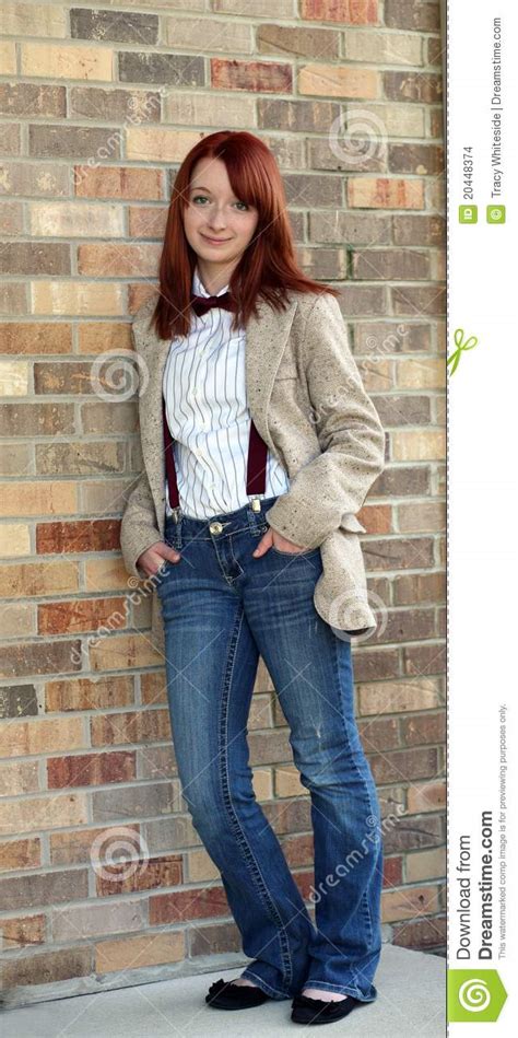 redhead teen girl against brick wall stock images image 20448374
