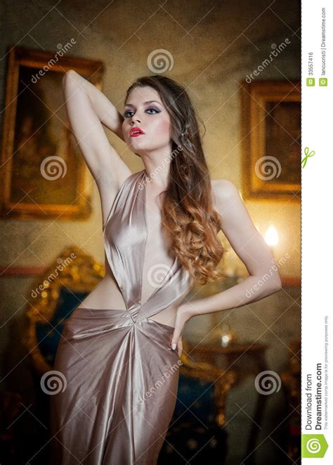 seductive brunette woman in luxury manor vintage style