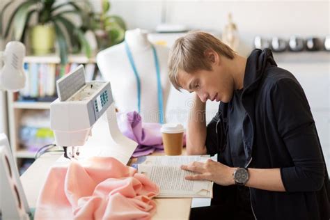 fashion designer reading book  studio stock photo image  dressmaking mannequin