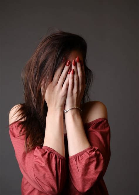 standing woman hiding face   hands  stock photo