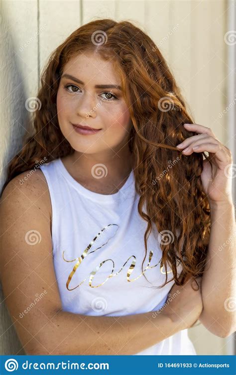 redhead model posing outdoors on an autumn day stock image