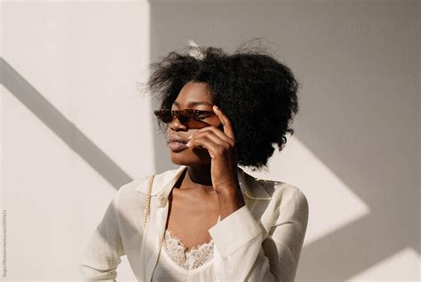 trendy black female in sunglasses by stocksy contributor serge