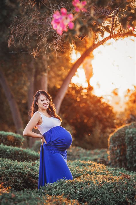 stunning full term expecting mother in white and blue dress in golden