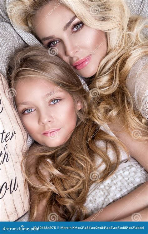 Portrait Of The Beautiful Blonde Woman Mother And Daughter On The My