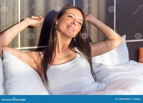 Morning Young Woman Waking Up Stretching Her Arms Lying In Bed Stock