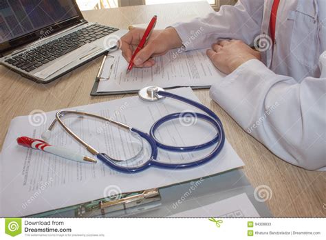 hand of specialist on a prescription female medical doctor writing