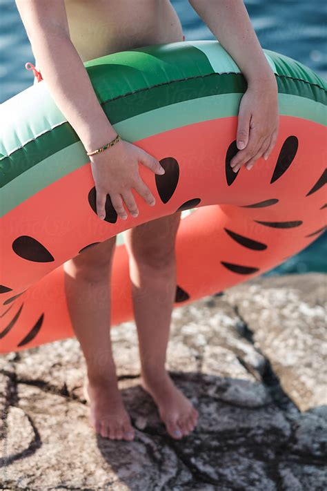 close up of an anonymous woman holding inflatable watermelon tube at