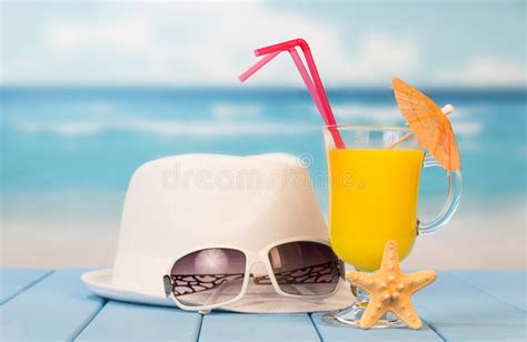 Straw Hat With A Exotic Cocktail And Sunglasses On Sand Beach Stock