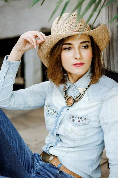 woman  western wear  cowboy hat jeans  cowboy boots stock