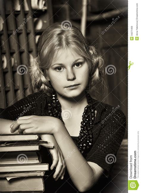 Teen Girl In Retro Style With A Stack Of Books Stock Image