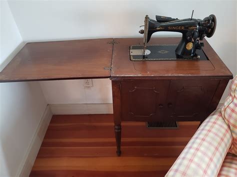 singer sewing machine  wooden cabinet  great shape worth serial number