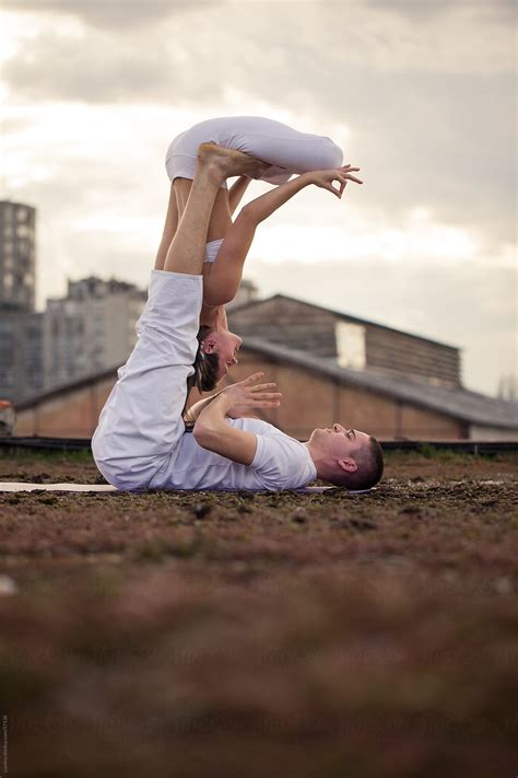 couple doing acro yoga stocksy united