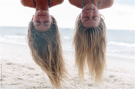 Upside Down Girls Having Fun At The Beach By Stocksy Contributor