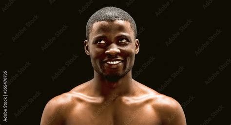 Naked African Man Toothy Smiles Looking Up On Black Background
