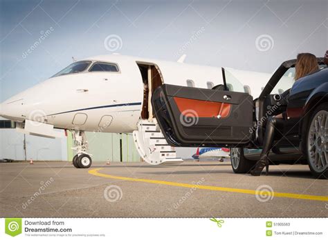 Woman Convertable Car And Corporate Private Jet Stock