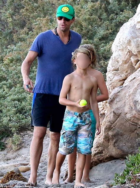 chris martin hits the beach for father son time with moses daily mail online