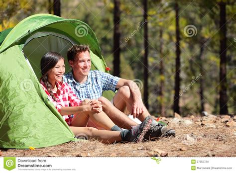 Camping Couple In Tent Sitting Looking At View Stock