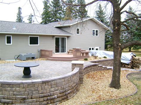 raised paver patio  retaining walls stairs deck  seating wall