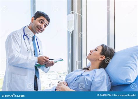 Doctor Check Up And Report Examination For Woman Patient At Hospital Or