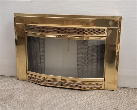 brass fireplace surround  glass doors     auction company