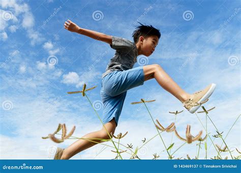 young boy run  jump stock image image  smile success