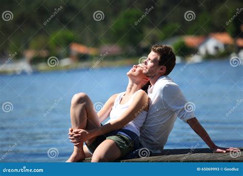 Young Couple Relaxing By Lake Stock Image Image Of Holidays Love