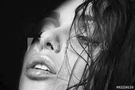 wet woman portrait with water drops on the face black and white stock